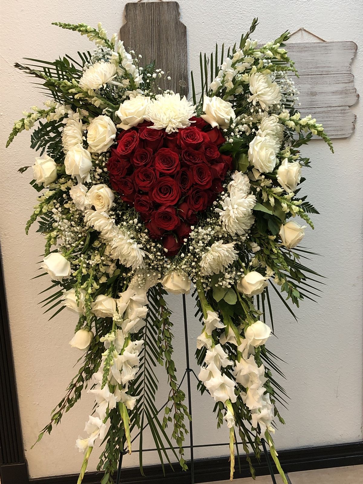Funeral standing spray with red and white roses
