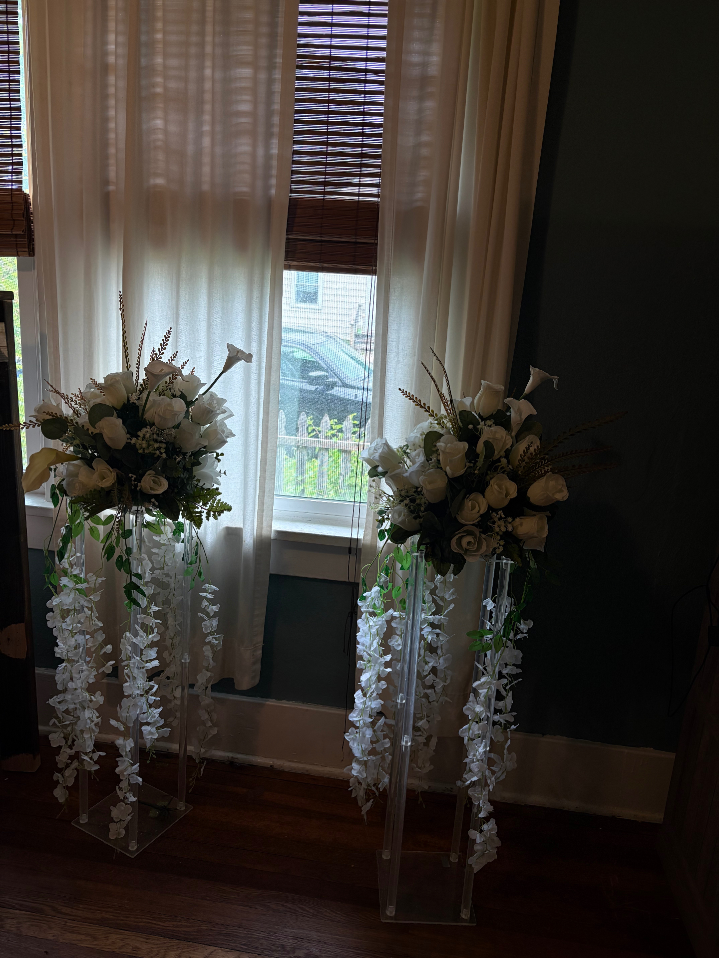 White rose and wisteria floral pillar arrangements for wedding ceremony